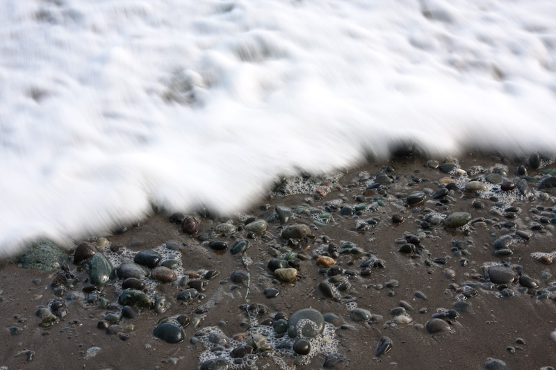 Wave Washing Over Pebbles